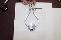 using a caliper to measure an object 822